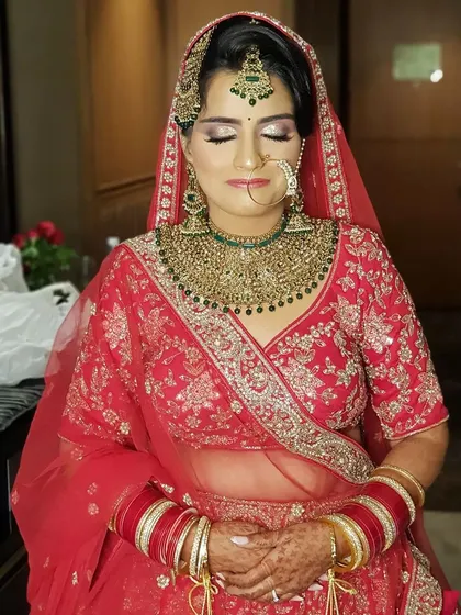My beautiful bride in a moment of calm. The makeup features a soft purple and silver glitter cut crease, paired with a flawless base and traditional green and gold jewelry.
