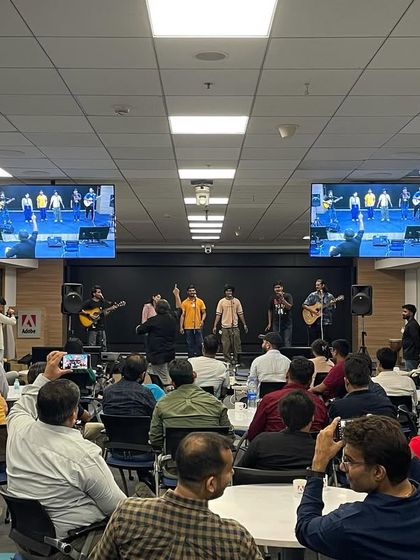 The audience at Adobe enjoying the performance by our Kalakaar fellows. The setup with multiple screens ensured everyone had a great view of the stage.