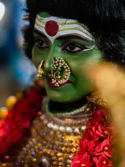 A close-up portrait of another performer with striking green makeup and an ornate nose ring. I focus on capturing the unique details of each artist's costume and expression.