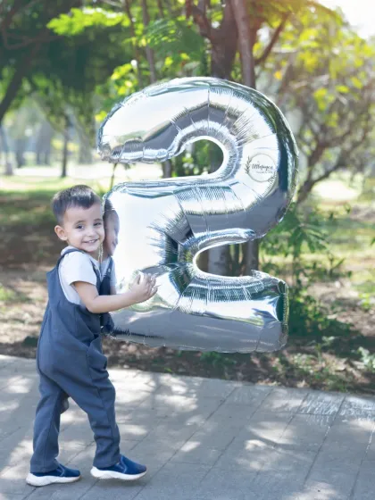 Two years old and full of smiles. I focus on making birthday milestone shoots fun and relaxed, letting your child's personality shine through. This outdoor portrait captures that wonderful, playful energy of being a toddler.
