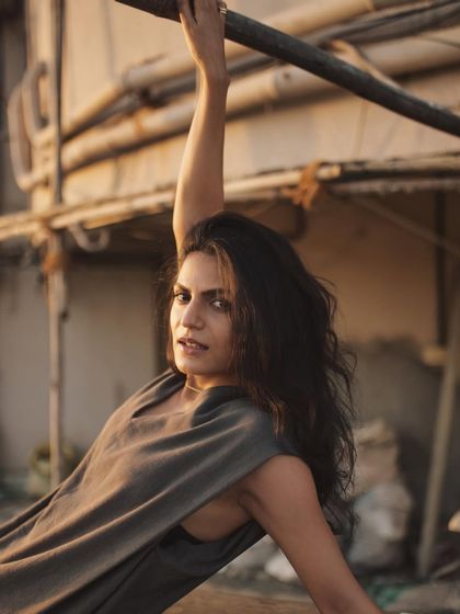 A dynamic pose that uses the environment to create strong leading lines and a sense of graceful movement.