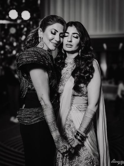 A quiet, emotional moment between the bride and her mother or mother-in-law during the reception.