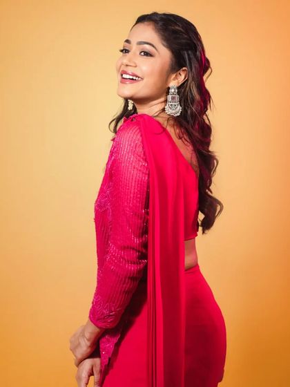 This profile shot shows how the modern saree drapes beautifully, creating a sleek and stylish silhouette for the actress. It's a great example of contemporary Indian wear for events.