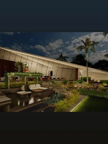 We design and build expansive farmhouse estates that harmonize architecture with nature. This one-acre project features a modern, angular main house seamlessly connected to a tranquil landscape with a custom water body and sunken seating.