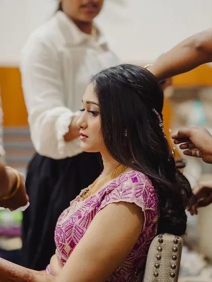 A behind-the-scenes moment during the sangeeth getting-ready process. It takes a team to create the perfect look.