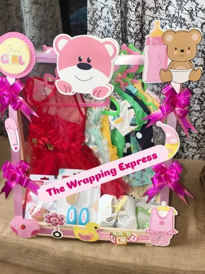 For a baby girl, I design these adorable 'Baby Wardrobe' hampers. This one is packed with cute dresses, shoes, and accessories, all decorated in a lovely pink theme to celebrate the arrival of a little princess.