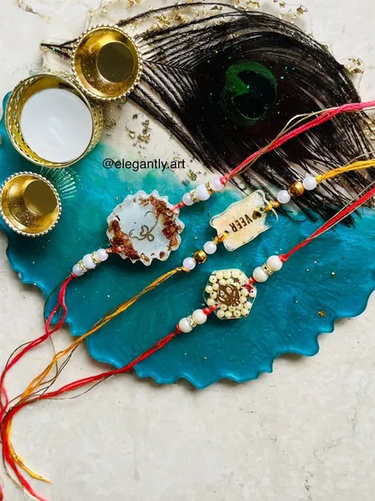 A beautiful Rakshabandhan hamper with custom resin Rakhis and a peacock feather-themed thali.