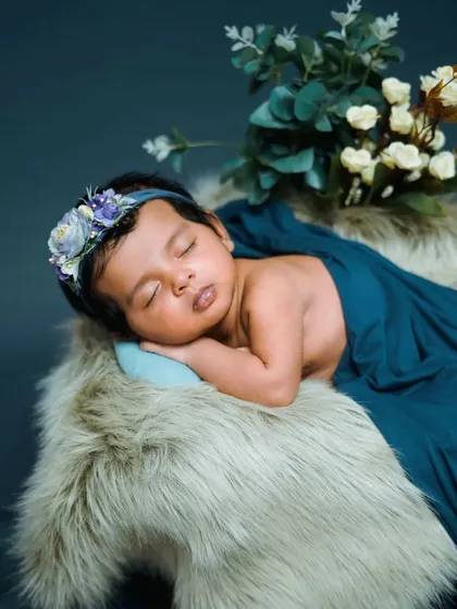 A duplicate of image 12, this classic pose is a great example of my consistent quality. A peaceful newborn on a fur rug with a floral headband.