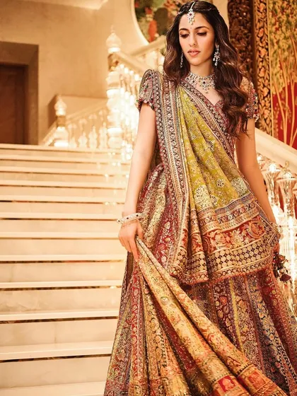 A full view of this gorgeous Tarun Tahiliani lehenga, showcasing the rich, earthy tones and detailed embroidery. It’s a perfect outfit for a garba night or any festive wedding event.