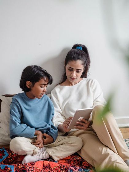 A quiet moment at home with a mother and child reading together. Lifestyle photography is about capturing the real, everyday beauty of your family life.