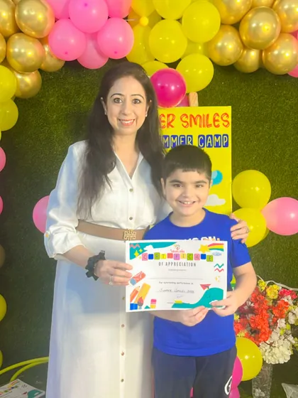 A big, bright smile from one of our happy campers. We believe in celebrating every child's effort and enthusiasm at the end of our summer program.