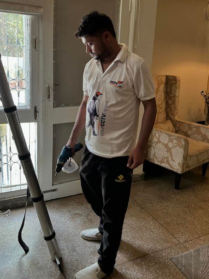 My technician, equipped with a drill and ladder, is prepared for an installation inside a client's home. We treat every property with respect and care.