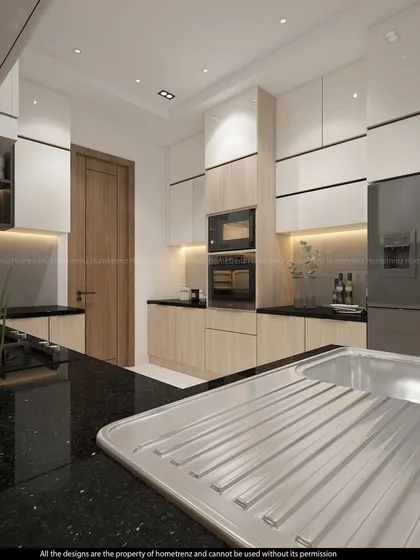 The black granite countertop and stainless steel sink provide a durable and stylish workspace in this kitchen.
