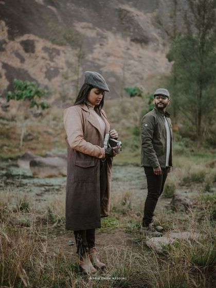 A candid shot of Ananthu and Sarga in a misty forest. This image captures a sense of adventure and shared journey, perfect for a cinematic pre-wedding film.
