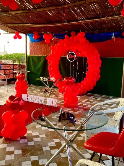 A wider view of a terrace proposal setup, showing how I can transform a space. The red decor stands out beautifully against the outdoor setting, creating a private and special environment.