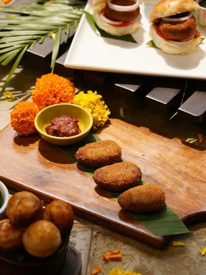 Our Easter spread includes a variety of delicious starters. Here, you can see our popular meat cutlets, crispy on the outside and tender on the inside, served with a tangy date and tamarind chutney.