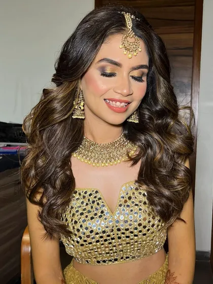 A close-up of the stunning Sangeet bride's makeup. The golden glitter eyeshadow makes her eyes sparkle.