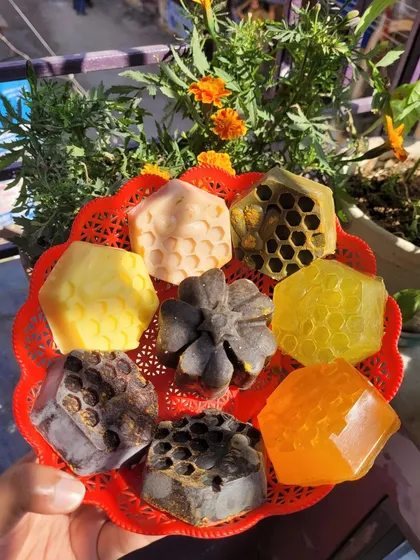 A variety of my facial soaps, including honeycomb and flower shapes, showcasing the different natural ingredients I use.