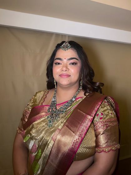 A beautiful portrait of a wedding guest. The makeup is subtle yet defining, with a focus on glowing skin and softly contoured features.