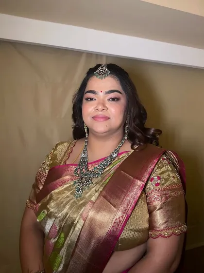 A beautiful portrait of a wedding guest. The makeup is subtle yet defining, with a focus on glowing skin and softly contoured features.