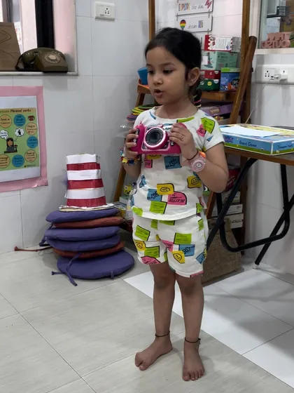 This young student chose her toy camera for "Share and Shine." It's a wonderful opportunity for her to practice speaking in front of her peers about an object that is important to her.