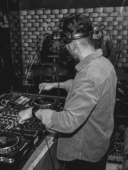 A black and white shot of me focused on the mixer. This highlights the technical side of my work, showing the precision that goes into every set.