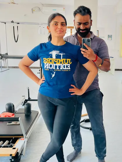 A proud client showing off her new t-shirt and her strong posture after a workout.