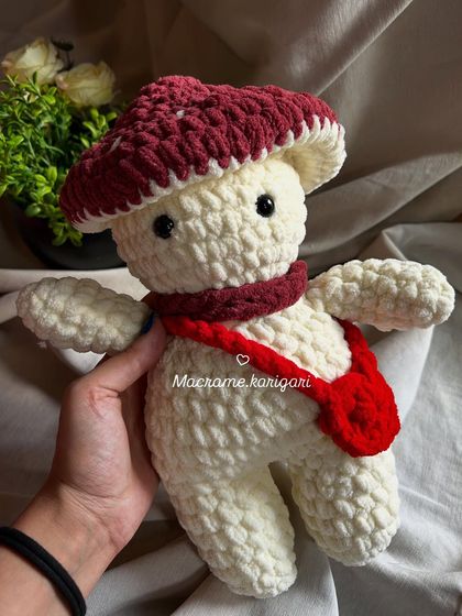 Holding our chunky yarn mushroom toy. It's soft, squishy, and the perfect size for little hands to hold.