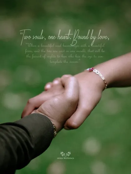 A close-up of the couple holding hands, a simple yet powerful symbol of their connection and shared journey.