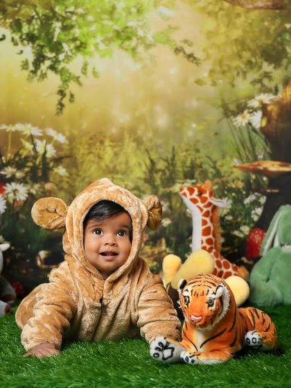 A wild adventure in our jungle theme. This little one is dressed as a cute cub, surrounded by friendly stuffed animals.