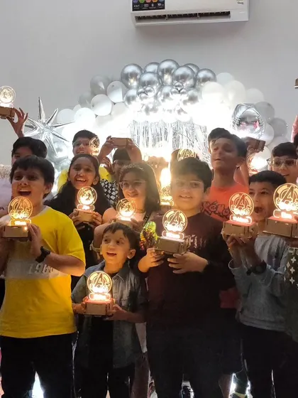 Look at those happy faces! A group of young innovators proudly shows off the custom light-up lamps they built themselves during one of our science-themed birthday parties.