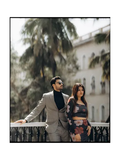A stylish portrait with the city's architecture in the background. The composition gives a sense of place while keeping the focus on the couple's cool, confident presence.