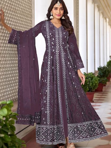 A stunning purple Anarkali with intricate thread, zari, and sequence work. The flowing silhouette and rich color make it a perfect choice for a sangeet or reception.