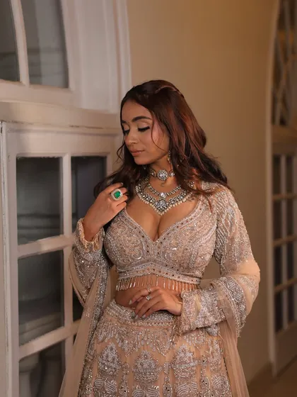 A close-up of a model in a stunning silver-grey lehenga, perfect for an engagement party. The intricate beadwork on the blouse is absolutely captivating.
