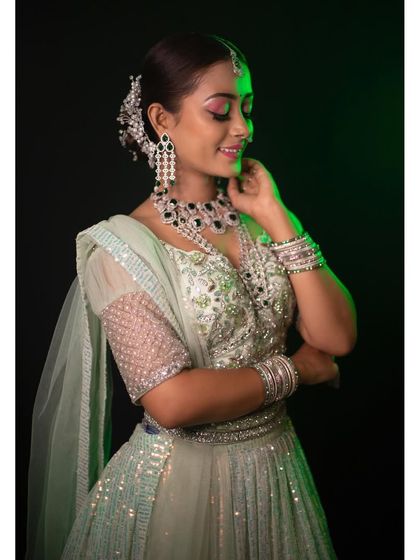 This client is glowing in a pastel green sequin lehenga. The intricate mirror work and shimmering sequins make this a dazzling choice for an evening reception or sangeet.