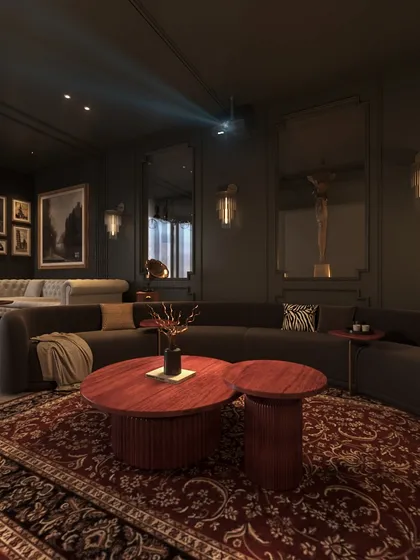 The projector is discreetly mounted on the ceiling, casting an image onto a large screen. The dark walls and plush furnishings create an immersive home theatre experience.