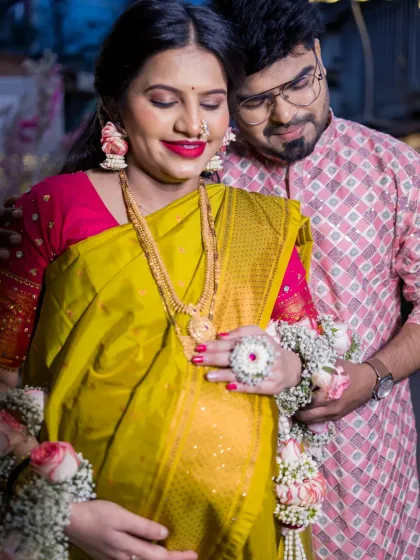 An intimate close-up of the couple embracing, with a focus on the baby bump. This photo captures the warmth and affection between them during their traditional Dohale Jevan, a perfect example of a couple maternity portrait.