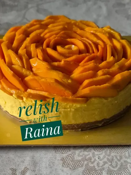 My eggless Mango Cheesecake, a seasonal favourite during the summer. It has a creamy texture and is topped with a decorative rose made entirely of fresh Alphonso mango slices.