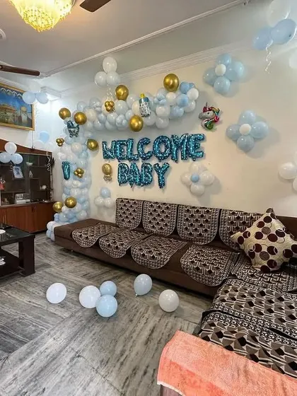 This wide shot shows how the "Welcome Baby" decoration can fill a living room space, creating a festive atmosphere for the family.