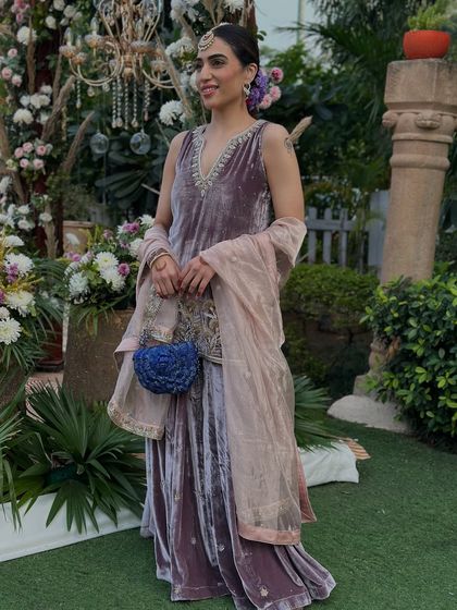 For the Anand Karaj ceremony, I designed this mauve velvet sharara suit. The intricate hand embroidery on the kurta adds a touch of heritage and craftsmanship.