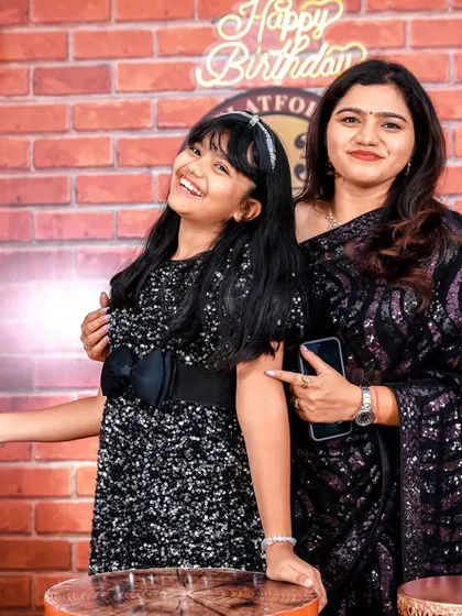 A joyful moment between mother and daughter at a Harry Potter themed birthday party.