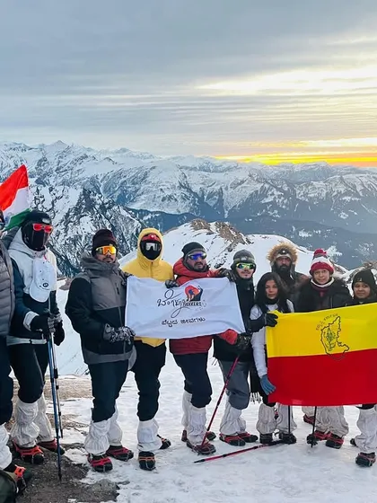 This is what pure joy and achievement look like. Our group at the Kedarkantha summit, proudly holding the flags high. We handle all the logistics so you can focus on moments like this.