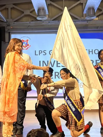 The ceremonial handover of the School Flag to the new Head Girl and Head Boy. This moment symbolizes the transfer of responsibility and the trust we place in our student leaders.