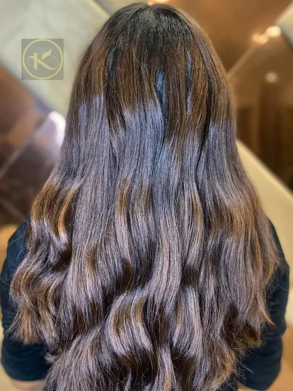 A beautiful example of balayage on long, wavy hair. The mix of brown and caramel tones creates a rich, multi-dimensional look.