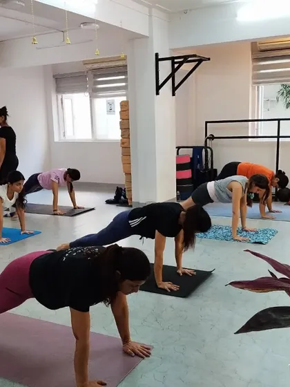 Building core strength is fundamental to our practice. Here, students hold Phalakasana (Plank Pose) with focus and determination.