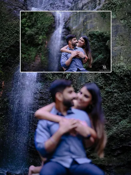 A creative composition from a waterfall pre-wedding shoot. The blurred foreground focuses the viewer's attention on the couple's happy interaction in the background.