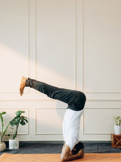 A controlled variation of Sirsasana (Headstand) with legs parallel to the floor, requiring immense core strength.