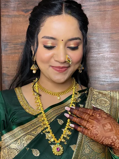 A close-up showing the intricate details of her henna and the perfectly applied makeup.