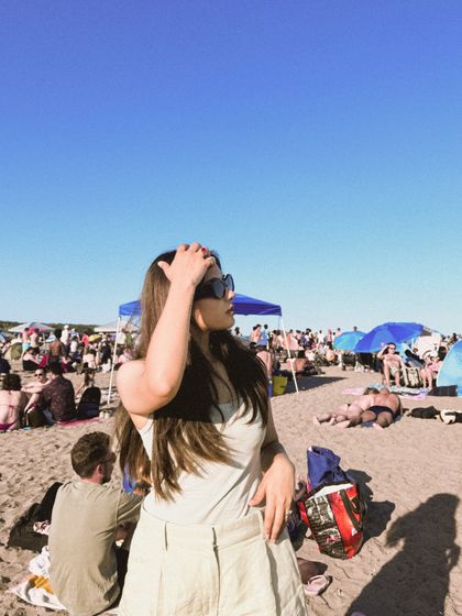 A candid shot from a crowded beach on Canada Day, capturing the festive, sunny atmosphere.