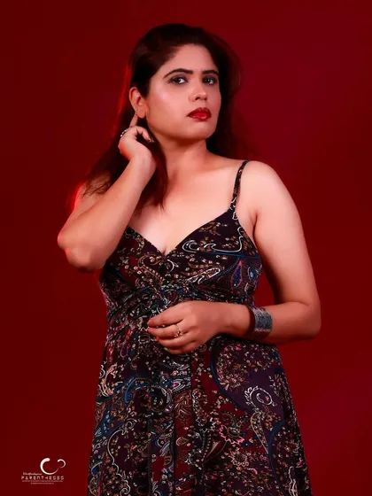 A thoughtful and elegant pose. The lighting is soft, and her expression is serene.
